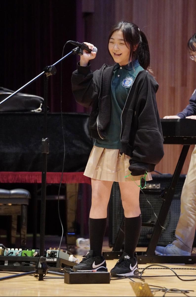Olivia Cho in seventh grade hypes up the audience with her upbeat vocals and bright smile. She performs "Lucky Strike" by Maroon 5 along with her band "Rocking Tangerines." 